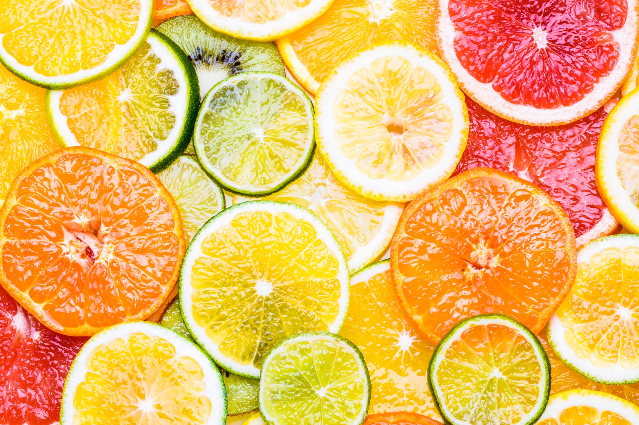 Fresh citrus fruits sliced assortment top view flat lay background.